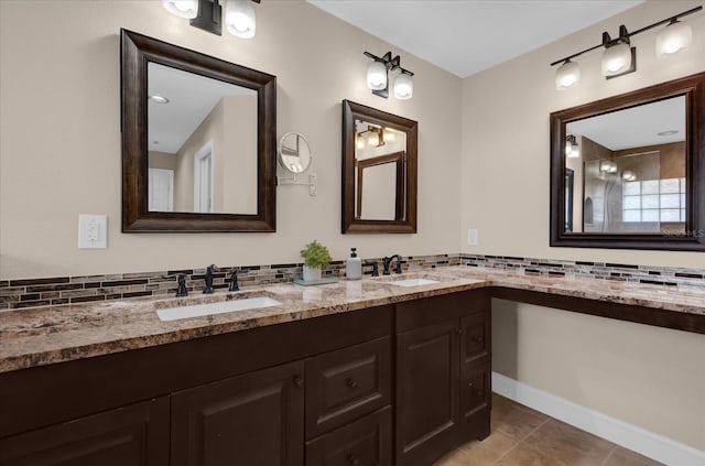 bathroom featuring vanity, backsplash, and tile patterned flooring