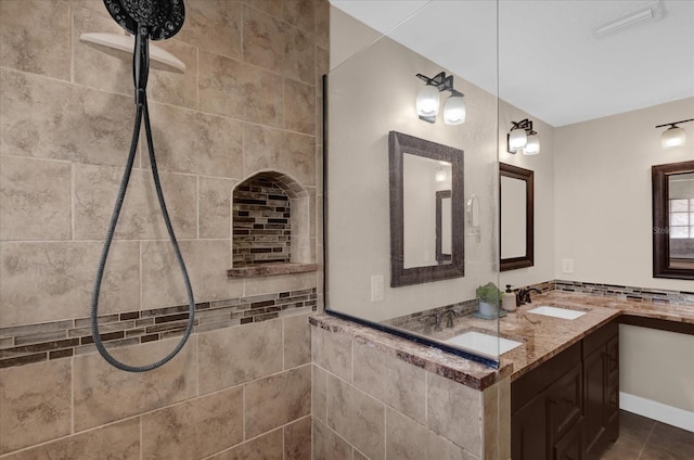 bathroom with vanity and tiled shower