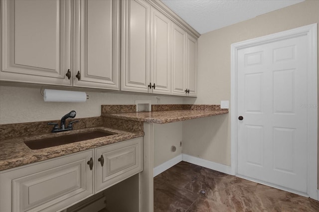 washroom featuring cabinets, sink, washer hookup, and a textured ceiling