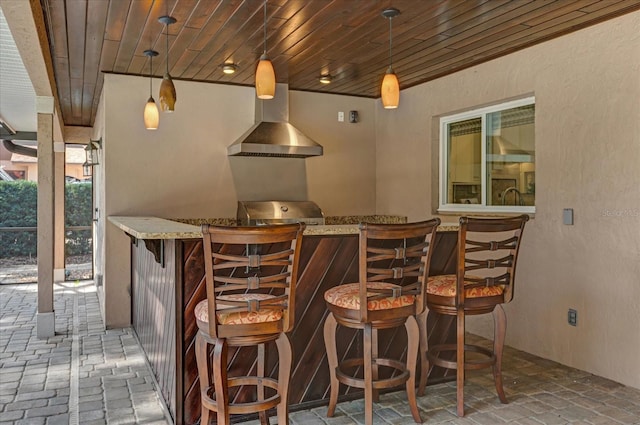 bar featuring pendant lighting, wood ceiling, and wall chimney range hood