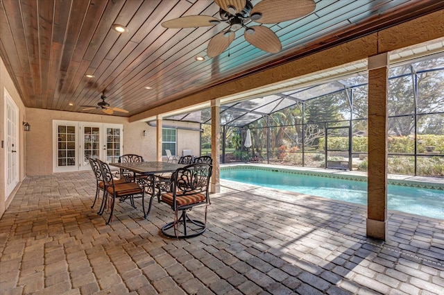 view of swimming pool featuring a lanai, a patio, and ceiling fan