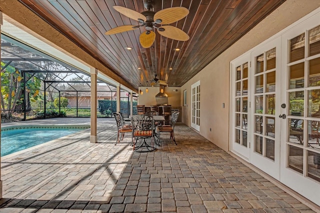 view of patio / terrace with ceiling fan, glass enclosure, and french doors