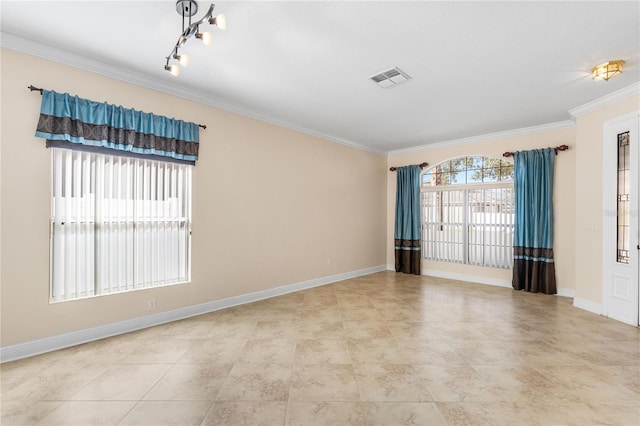 tiled spare room featuring crown molding