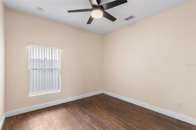 empty room with dark wood-type flooring and ceiling fan