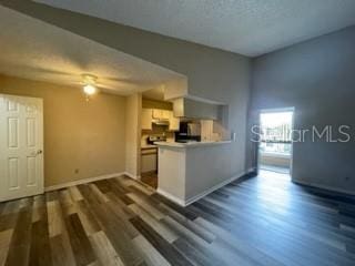 kitchen with white cabinetry and dark wood-type flooring