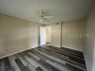 empty room with dark hardwood / wood-style floors