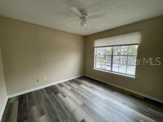 spare room with ceiling fan and wood-type flooring