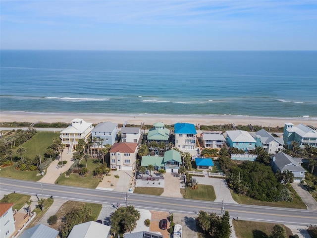 aerial view with a water view and a beach view