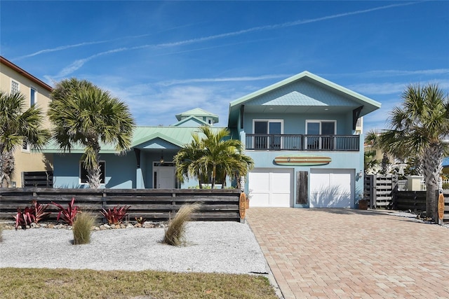 beach home with a garage and a balcony