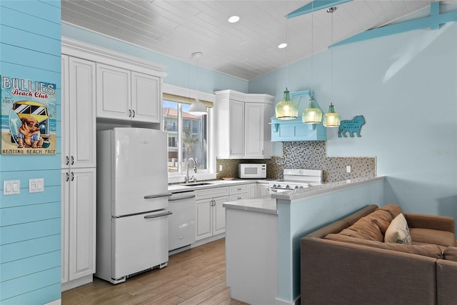 kitchen with white cabinetry, sink, white appliances, and decorative light fixtures