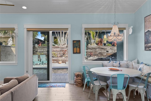 dining area featuring an inviting chandelier, wood-type flooring, and breakfast area