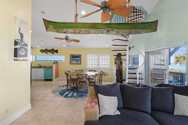 tiled living room featuring a towering ceiling and ceiling fan