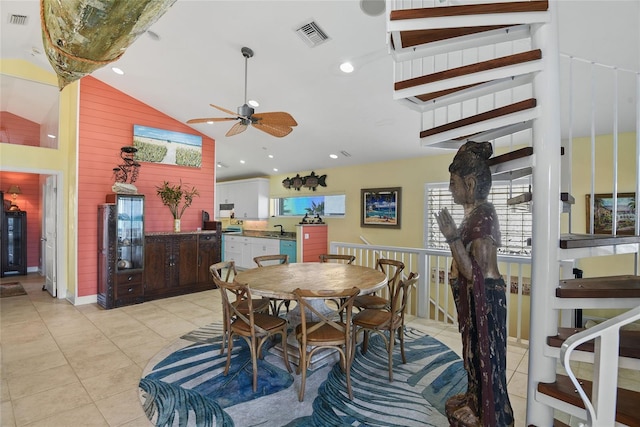 dining space featuring lofted ceiling, light tile patterned floors, sink, and ceiling fan