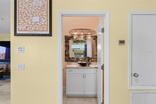 hallway featuring sink and light tile patterned floors