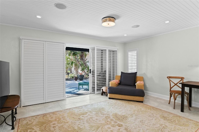 living area featuring light tile patterned flooring, wood ceiling, and crown molding