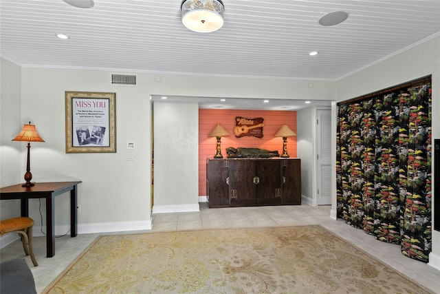 interior space featuring light tile patterned flooring and ornamental molding