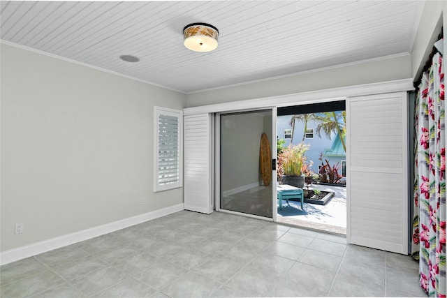 tiled empty room with crown molding