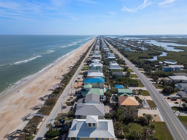 aerial view with a water view and a view of the beach