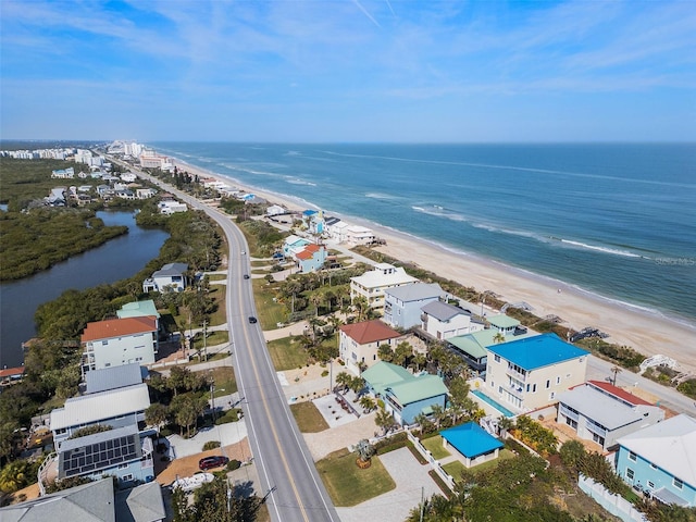 aerial view featuring a water view and a beach view