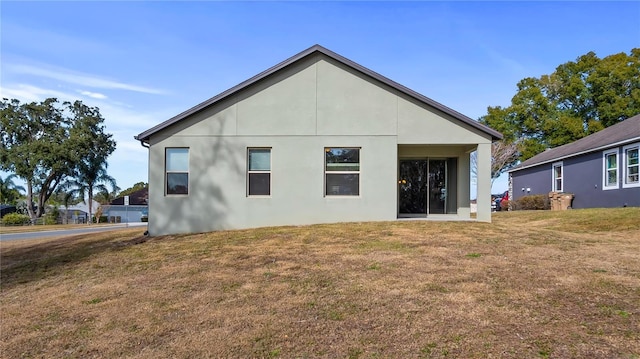 back of house with a lawn