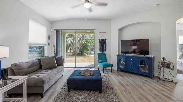 living room featuring vaulted ceiling, ceiling fan, and light hardwood / wood-style flooring