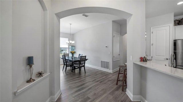 interior space featuring hardwood / wood-style flooring and an inviting chandelier