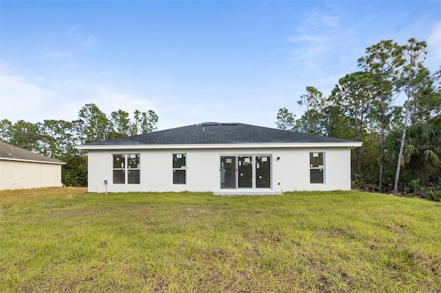 back of house featuring a lawn