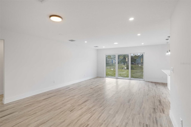 spare room featuring light hardwood / wood-style flooring