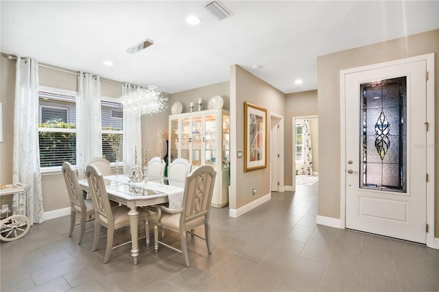 dining area featuring plenty of natural light and a chandelier