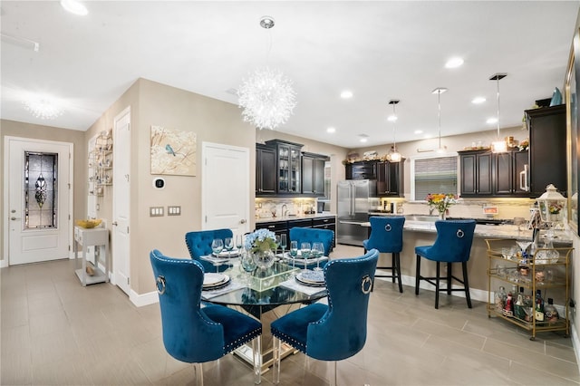 dining space featuring sink and a chandelier