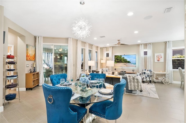 dining room featuring ceiling fan with notable chandelier