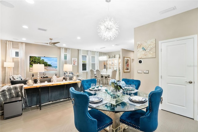 dining room featuring ceiling fan with notable chandelier