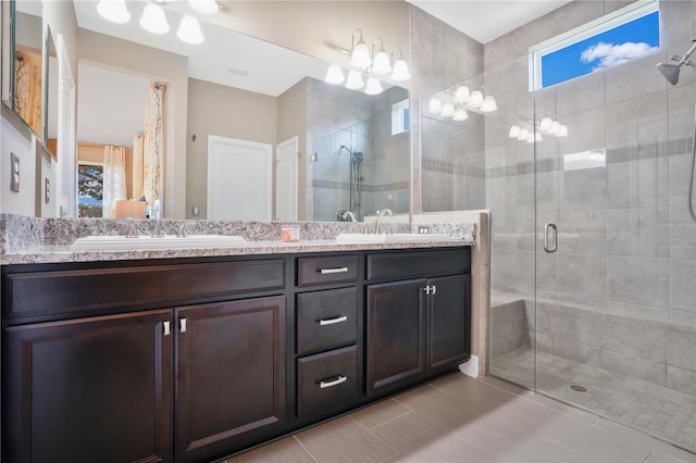 bathroom with a shower with door and vanity