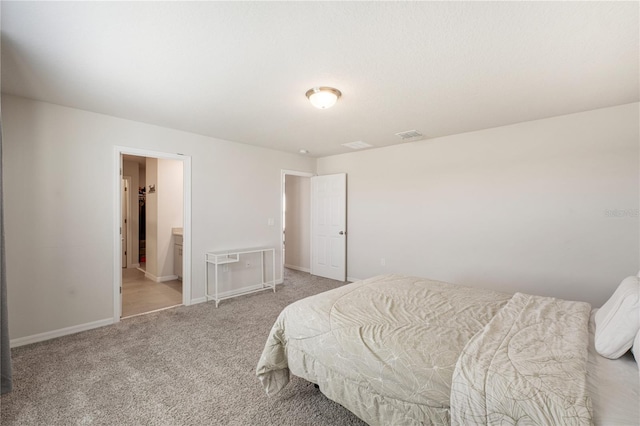 carpeted bedroom featuring visible vents and baseboards