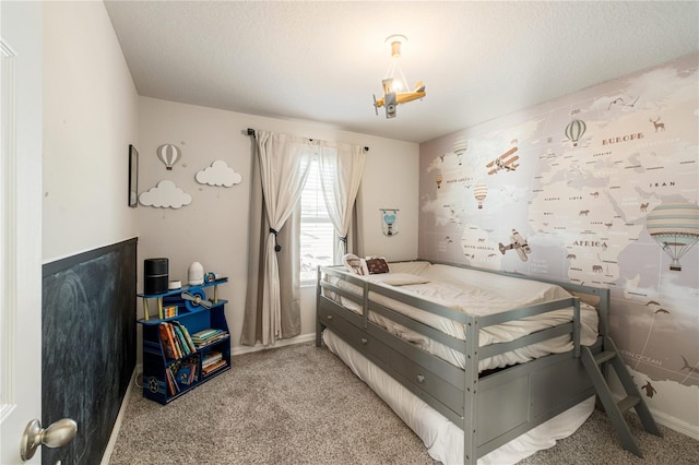 bedroom featuring a textured ceiling and light colored carpet