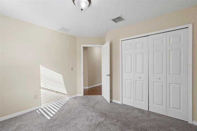 unfurnished bedroom featuring carpet floors and a closet