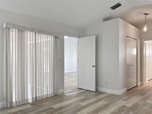 empty room with light hardwood / wood-style floors