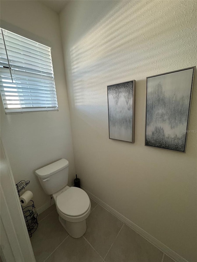 bathroom featuring tile patterned flooring and toilet