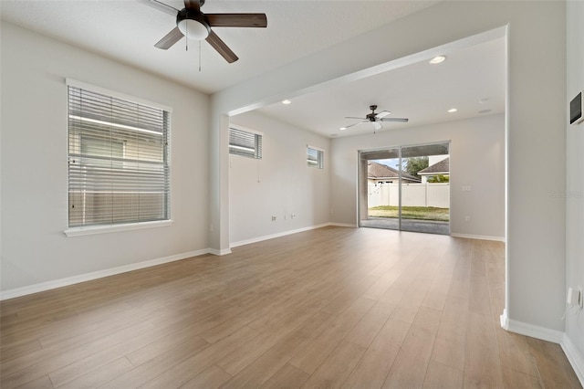 spare room with ceiling fan and light hardwood / wood-style flooring