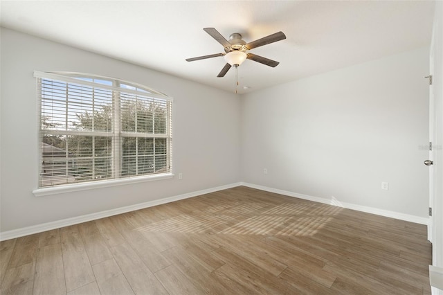 empty room with hardwood / wood-style flooring and ceiling fan