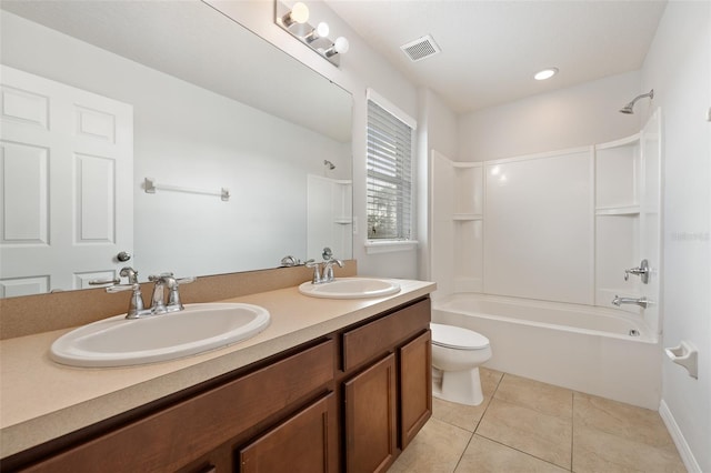 full bathroom featuring washtub / shower combination, vanity, toilet, and tile patterned flooring