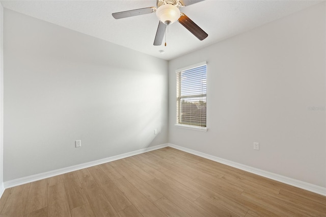 empty room with ceiling fan and light hardwood / wood-style floors