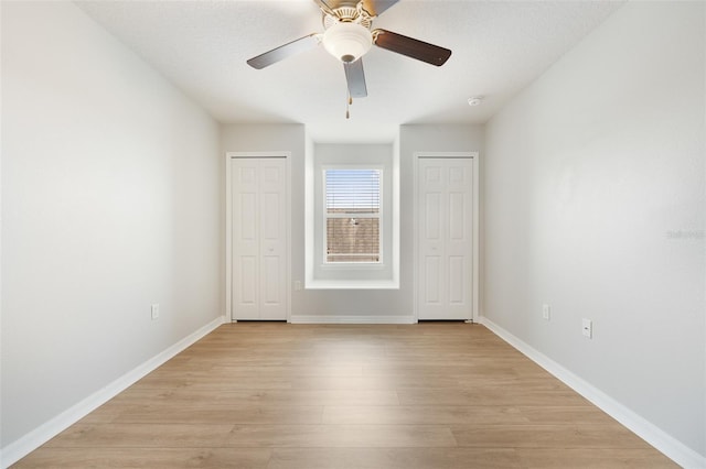 unfurnished bedroom featuring ceiling fan and light wood-type flooring