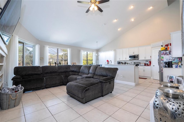 tiled living room featuring ceiling fan and high vaulted ceiling