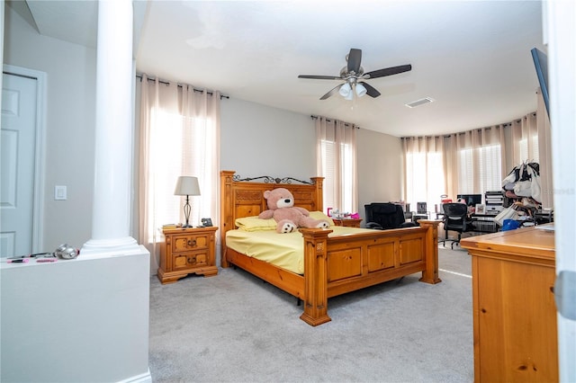 carpeted bedroom with decorative columns