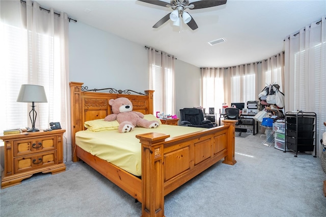 bedroom with ceiling fan and light colored carpet