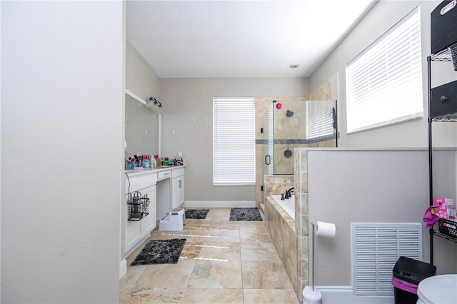 bathroom with vanity and independent shower and bath