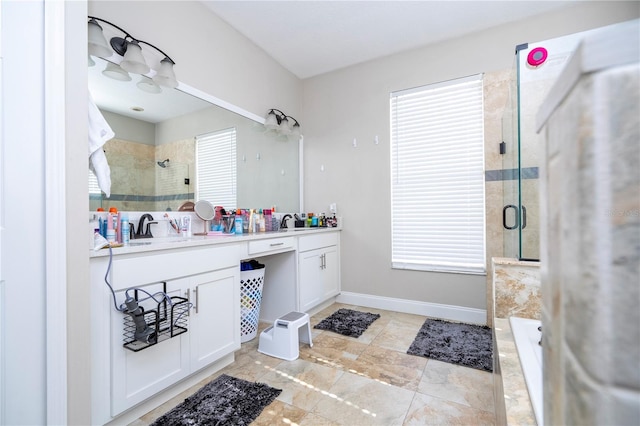 bathroom with vanity, plenty of natural light, and walk in shower