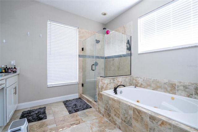 bathroom with vanity, shower with separate bathtub, and a healthy amount of sunlight