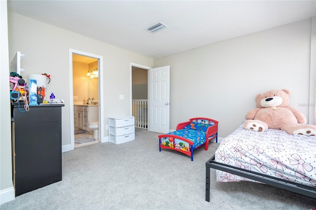 carpeted bedroom featuring connected bathroom